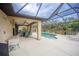 Screened outdoor pool area with ceiling fans and a dining table at 17327 Wintergarden Ave, Port Charlotte, FL 33948