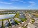 Community aerial view featuring beautiful homes surrounding a peaceful lake, showcasing a desirable neighborhood at 17954 Saddle Rd, Punta Gorda, FL 33982