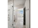 Bathroom with a tiled shower stall and view into the bedroom at 17954 Saddle Rd, Punta Gorda, FL 33982