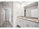 Bathroom with a double sink vanity, granite countertop, and a glass-enclosed shower at 17954 Saddle Rd, Punta Gorda, FL 33982