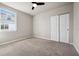 Bedroom with a ceiling fan, neutral carpeting, and a double-door closet at 17954 Saddle Rd, Punta Gorda, FL 33982