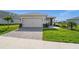 Charming single-story home featuring a two-car garage and a well-manicured front yard with stone driveway at 17954 Saddle Rd, Punta Gorda, FL 33982
