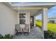 Charming front porch with seating, stone pavers, and a view of the manicured lawn at 17954 Saddle Rd, Punta Gorda, FL 33982