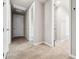 Hallway featuring multiple entryways and durable tile flooring throughout the home at 17954 Saddle Rd, Punta Gorda, FL 33982