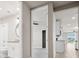 Hallway with access to a bathroom, bedroom, and a glimpse of the modern kitchen at 17954 Saddle Rd, Punta Gorda, FL 33982