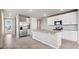 Bright kitchen with a large island, stainless steel appliances, white cabinets, and a tile backsplash at 17954 Saddle Rd, Punta Gorda, FL 33982