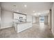 Spacious kitchen featuring a center island, stainless appliances, and an open view into the living room at 17954 Saddle Rd, Punta Gorda, FL 33982