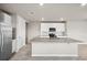 Modern kitchen featuring stainless steel appliances, granite countertops, a large island, and white cabinets at 17954 Saddle Rd, Punta Gorda, FL 33982