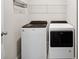 Bright laundry room featuring new washer and dryer, plus convenient overhead storage at 17954 Saddle Rd, Punta Gorda, FL 33982