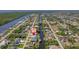 Panoramic aerial view captures the property's location on a canal with ocean access, surrounded by lush greenery at 18662 Arapahoe Cir, Port Charlotte, FL 33948