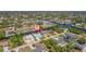 An aerial view showcases the neighborhood homes and waterfront property, surrounded by mature trees at 18662 Arapahoe Cir, Port Charlotte, FL 33948