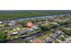 This aerial photo captures the waterfront homes nestled along canals surrounded by mature trees at 18662 Arapahoe Cir, Port Charlotte, FL 33948