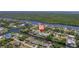 This aerial image showcases the property, waterfront access, and the surrounding neighborhood by the ocean at 18662 Arapahoe Cir, Port Charlotte, FL 33948