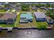 Aerial view showing the property's waterfront location, with a boat lift and a spacious backyard at 18662 Arapahoe Cir, Port Charlotte, FL 33948