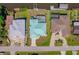 Aerial view of the home with a screened-in pool, canal access, and boat dock at 18662 Arapahoe Cir, Port Charlotte, FL 33948