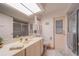 Bathroom with a skylight, vanity, and glass door shower at 18662 Arapahoe Cir, Port Charlotte, FL 33948