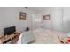 Bedroom with art on the walls, a bed, and access to other rooms at 18662 Arapahoe Cir, Port Charlotte, FL 33948