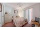 Bedroom with a ceiling fan, vertical blinds, and patterned bedding at 18662 Arapahoe Cir, Port Charlotte, FL 33948