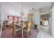 Open dining room with chandelier, hutch, access to living room and kitchen at 18662 Arapahoe Cir, Port Charlotte, FL 33948