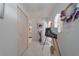 Bright entryway featuring white tile flooring, decorative artwork, and a glimpse of the home's interior at 18662 Arapahoe Cir, Port Charlotte, FL 33948