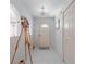 Bright entryway featuring white tile flooring, closet, decorative artwork, and a front door at 18662 Arapahoe Cir, Port Charlotte, FL 33948