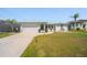 Charming home exterior features a manicured lawn, a two-car garage, and lush landscaping at 18662 Arapahoe Cir, Port Charlotte, FL 33948