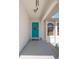 Welcoming front entrance with a turquoise door and a decorative wreath at 18662 Arapahoe Cir, Port Charlotte, FL 33948