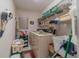 Laundry room with a washer and dryer, wire racks, and storage containers at 18662 Arapahoe Cir, Port Charlotte, FL 33948