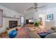 Cozy living room with fireplace, TV, and comfortable seating, ideal for relaxation at 18662 Arapahoe Cir, Port Charlotte, FL 33948