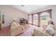 Bright living room with large windows, comfortable sofas, and a relaxing atmosphere at 18662 Arapahoe Cir, Port Charlotte, FL 33948