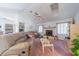 Spacious living room with vaulted ceilings, fireplace, and comfortable leather sofas at 18662 Arapahoe Cir, Port Charlotte, FL 33948