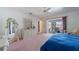 Comfortable main bedroom with sliding glass door to lanai, dresser, and cozy decor at 18662 Arapahoe Cir, Port Charlotte, FL 33948