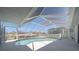 Enclosed pool with clear blue water and a screened enclosure with waterfront views at 18662 Arapahoe Cir, Port Charlotte, FL 33948