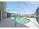 Screened-in pool area offering a refreshing pool and an outdoor relaxation space with bright light at 18662 Arapahoe Cir, Port Charlotte, FL 33948