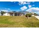 This backyard showcases a screened in patio at 20339 Gentry Ave, Port Charlotte, FL 33952