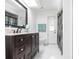 The bathroom features a large mirror, a marble countertop, and a toilet at 20339 Gentry Ave, Port Charlotte, FL 33952