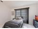 A simple bedroom has a twin bed, dresser, window with blinds, and white floors at 20339 Gentry Ave, Port Charlotte, FL 33952