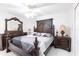 A primary bedroom with ornate dark wood furniture, a ceiling fan, and white walls at 20339 Gentry Ave, Port Charlotte, FL 33952