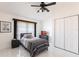 A simple bedroom has a twin bed, dresser, ceiling fan, and closet at 20339 Gentry Ave, Port Charlotte, FL 33952