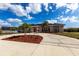 Stunning single-story home featuring a circular driveway, meticulously landscaped grounds, and a beautiful facade at 20339 Gentry Ave, Port Charlotte, FL 33952
