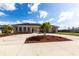 This home features circular driveway and well-manicured landscaping at 20339 Gentry Ave, Port Charlotte, FL 33952