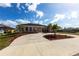 Home featuring a circular driveway and well-manicured landscaping at 20339 Gentry Ave, Port Charlotte, FL 33952