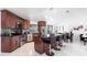 Open kitchen featuring an island with bar seating, stainless steel appliances, and a dining area at 20339 Gentry Ave, Port Charlotte, FL 33952