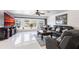 Spacious living room featuring large windows, leather furniture, and polished tile floors at 20339 Gentry Ave, Port Charlotte, FL 33952