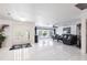 Bright open-concept living area with tile floors, neutral colors, and large windows at 20339 Gentry Ave, Port Charlotte, FL 33952
