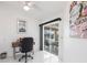 This home office has a chair, desk, and sliding glass doors leading to the lanai at 20339 Gentry Ave, Port Charlotte, FL 33952