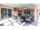 Spacious, covered patio with tile flooring and ample seating, perfect for relaxing or entertaining guests at 20339 Gentry Ave, Port Charlotte, FL 33952
