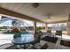 Screened-in patio with tiled floor, ceiling fan, comfortable seating, and views of the beautiful pool with a waterfall at 20339 Gentry Ave, Port Charlotte, FL 33952