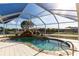 Screened in pool with waterfall feature and rock surround at 20339 Gentry Ave, Port Charlotte, FL 33952