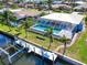 Aerial view of the property featuring a private dock, enclosed pool and the serene canal at 2180 Via Esplanade, Punta Gorda, FL 33950